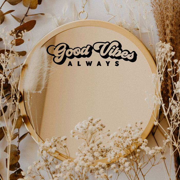Black “Good Vibes Always” vinyl sticker on a round mirror with dried flowers