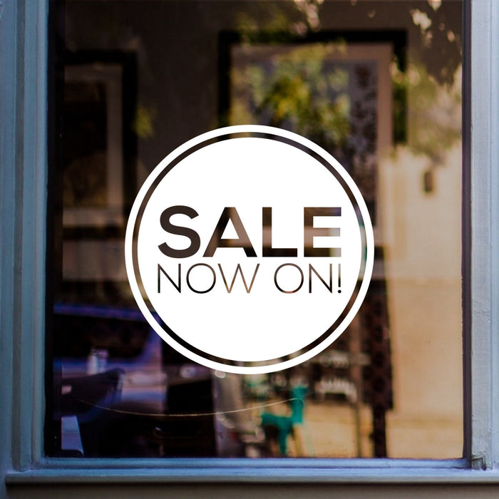 Sale Now On Shop Window Sticker shown on a blue-framed shop window