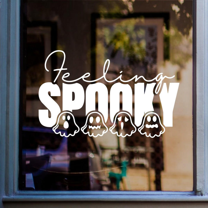 Feeling Spooky Ghosts Halloween Window Sticker: white vinyl design on a blue-framed glass door
