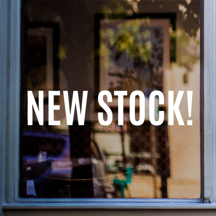 New Stock window sticker displayed on a shop window