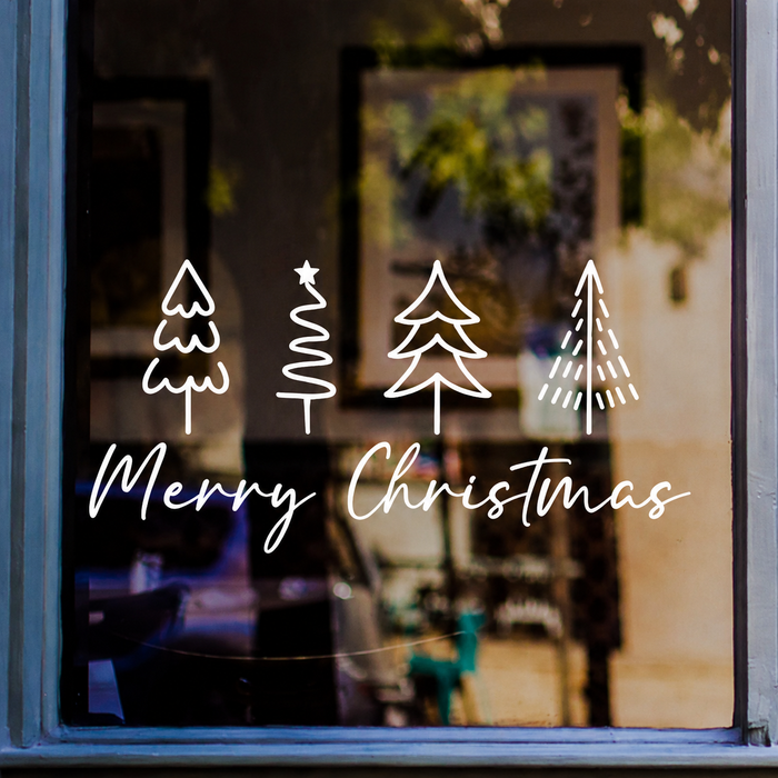 White Merry Christmas window sticker with four minimalist Christmas tree drawings displayed on a shop window
