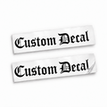 Two matching black Custom Decal vinyl stickers in ornate Old English blackletter on backing sheets against white.