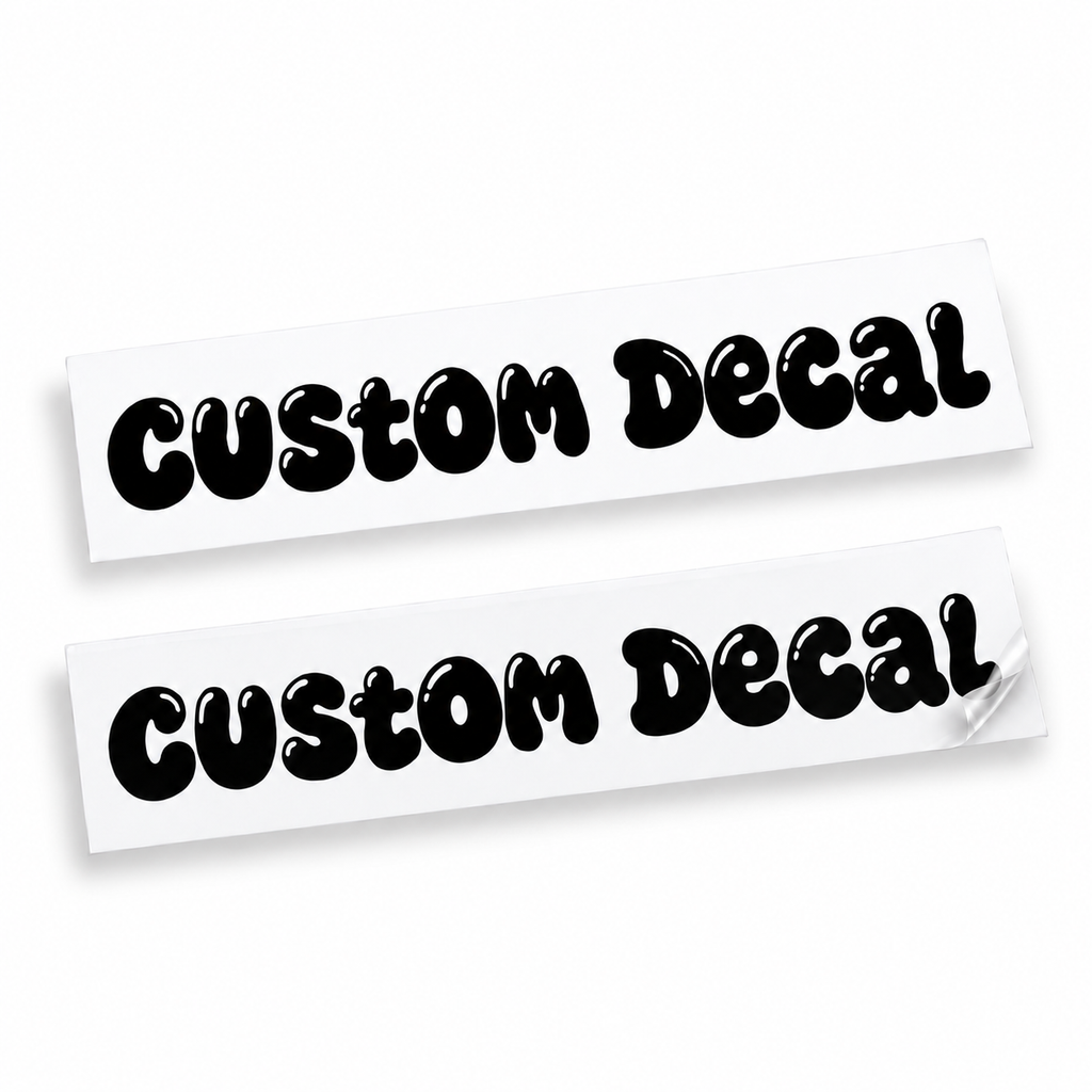 Two matching black custom text vinyl decals in rounded bubble lettering with cut-out details on backing sheets against white.