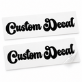 Two matching black Custom Decal vinyl stickers in flowing retro script lettering on backing sheets against white.