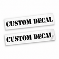 Two matching black Custom Decal vinyl stickers in bold stencil lettering on backing sheets against a white background.