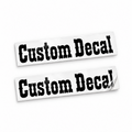 Two matching black Custom Decal vinyl stickers in bold western lettering on backing sheets against white.