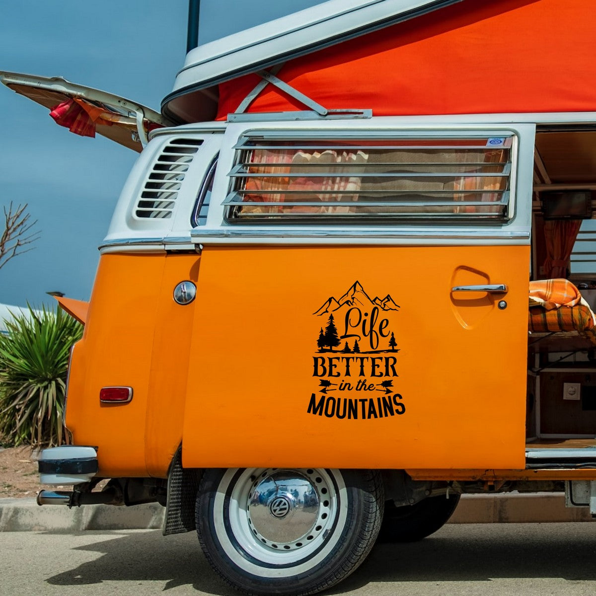 Life Is Better In The Mountains caravan sticker shown on an orange campervan