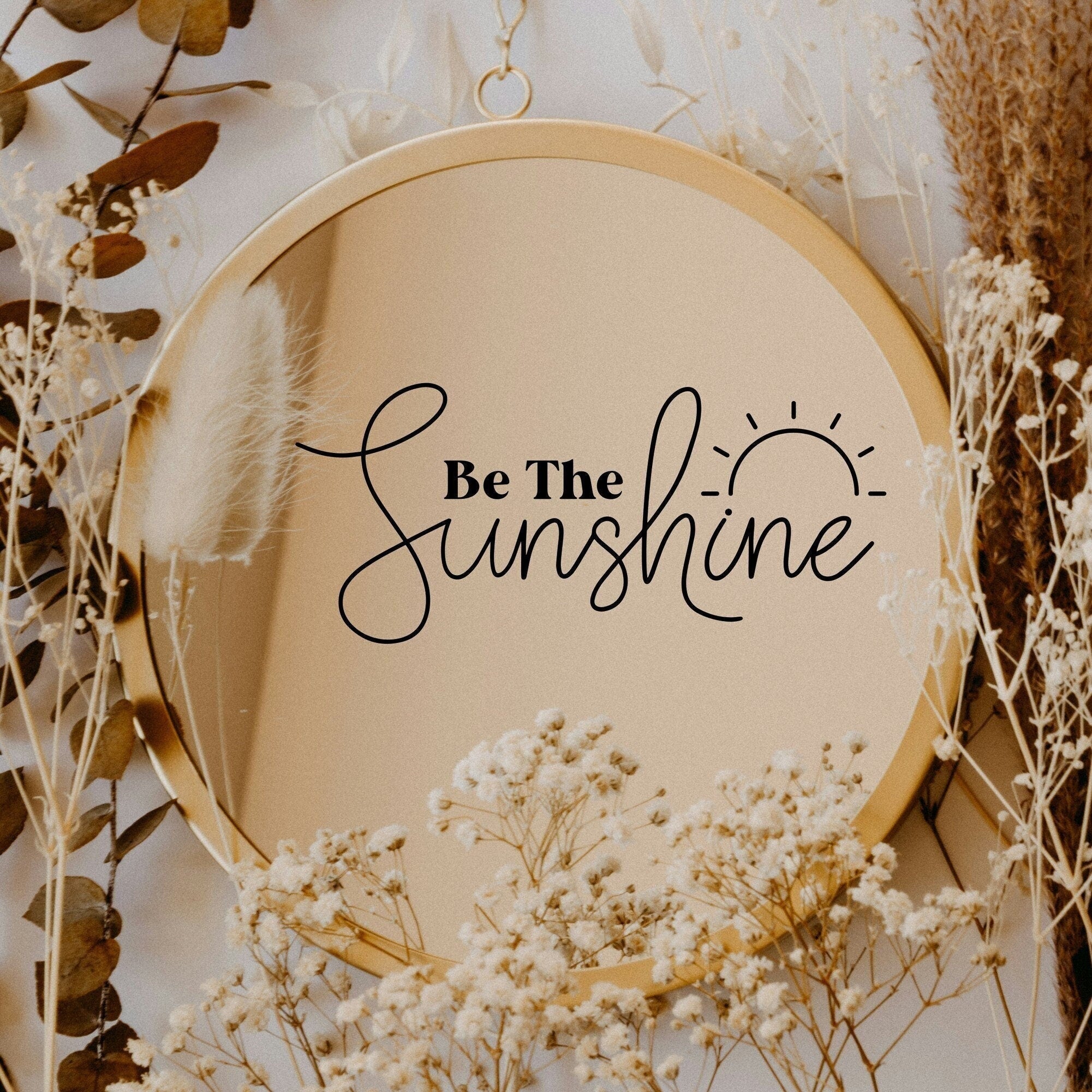 Black “Be The Sunshine” vinyl sticker on a round mirror with dried flowers