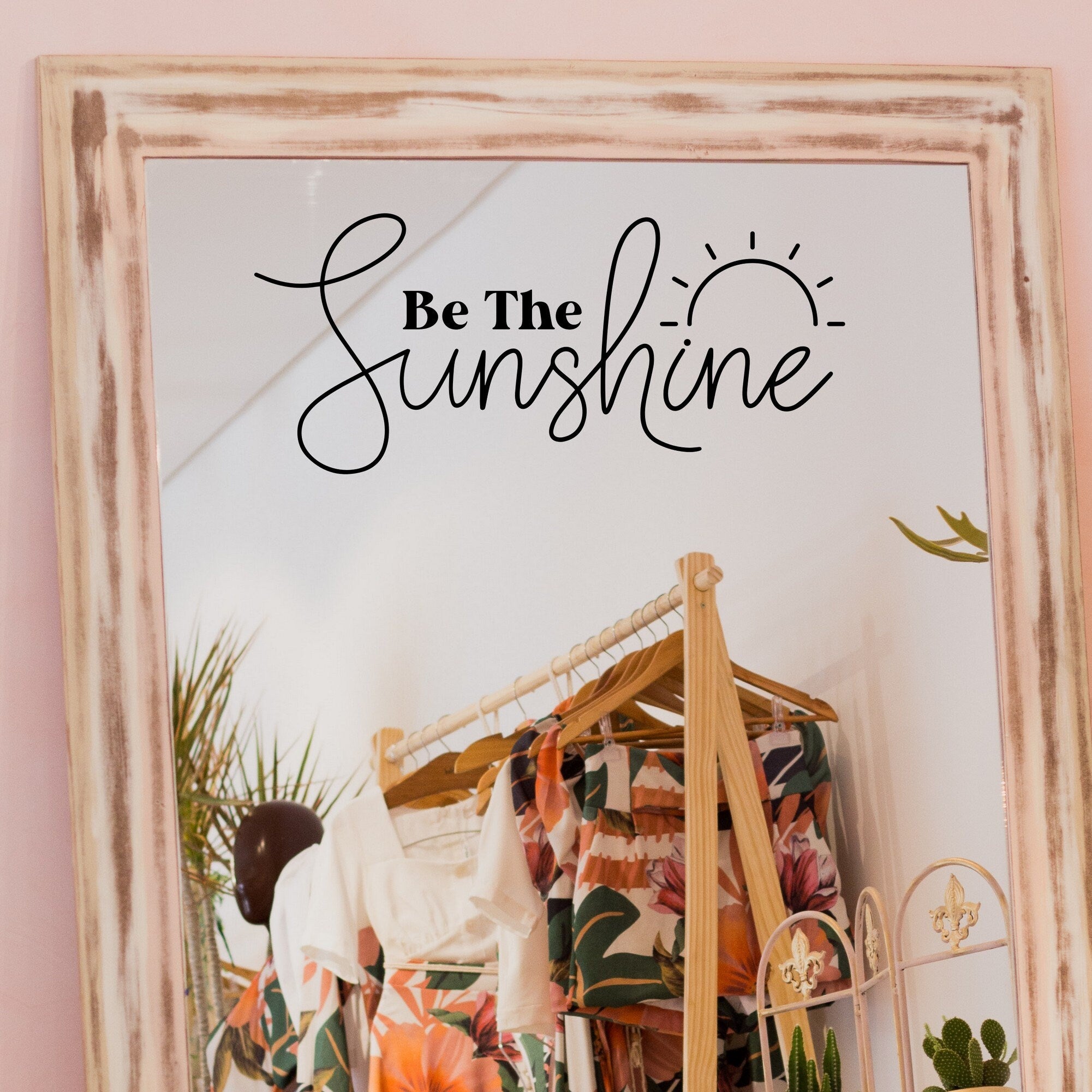 Black “Be The Sunshine” vinyl sticker on a framed dressing-room mirror