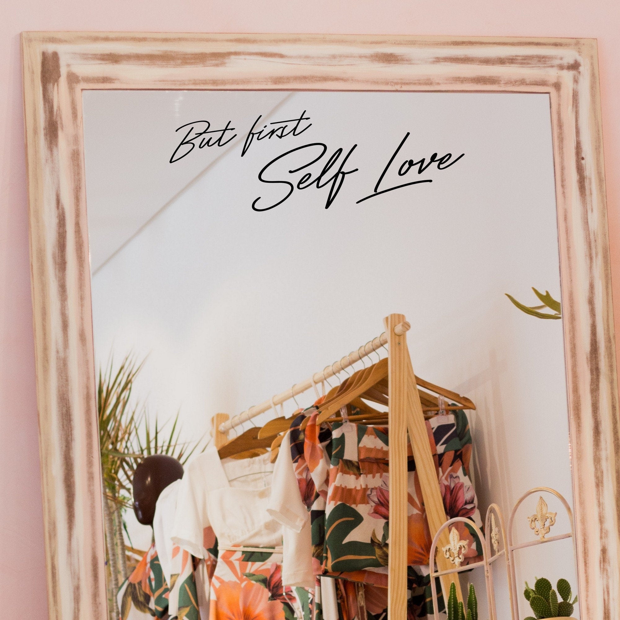 Black “But First Self Love” vinyl sticker on a framed dressing-room mirror