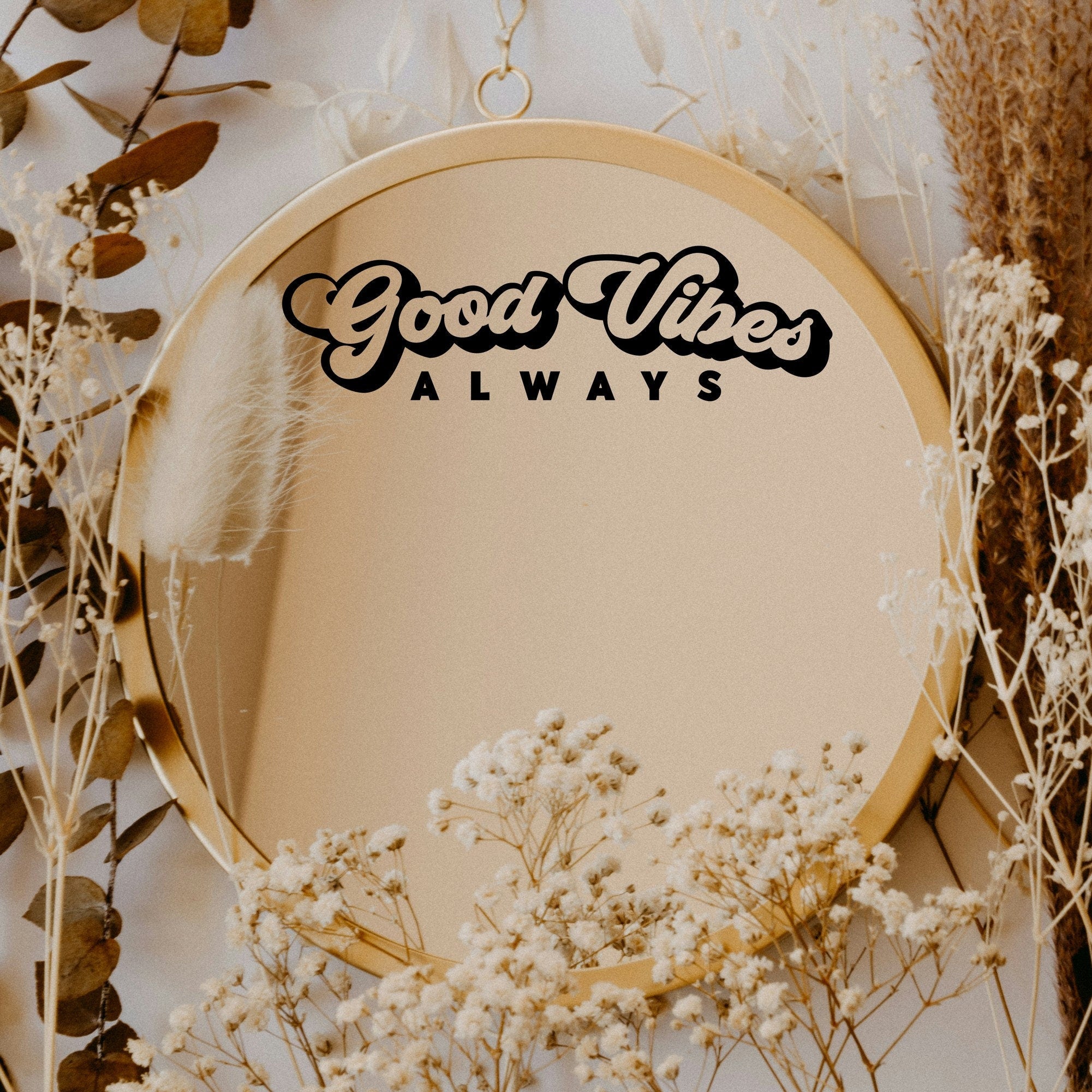 Black “Good Vibes Always” vinyl sticker on a round mirror with dried flowers