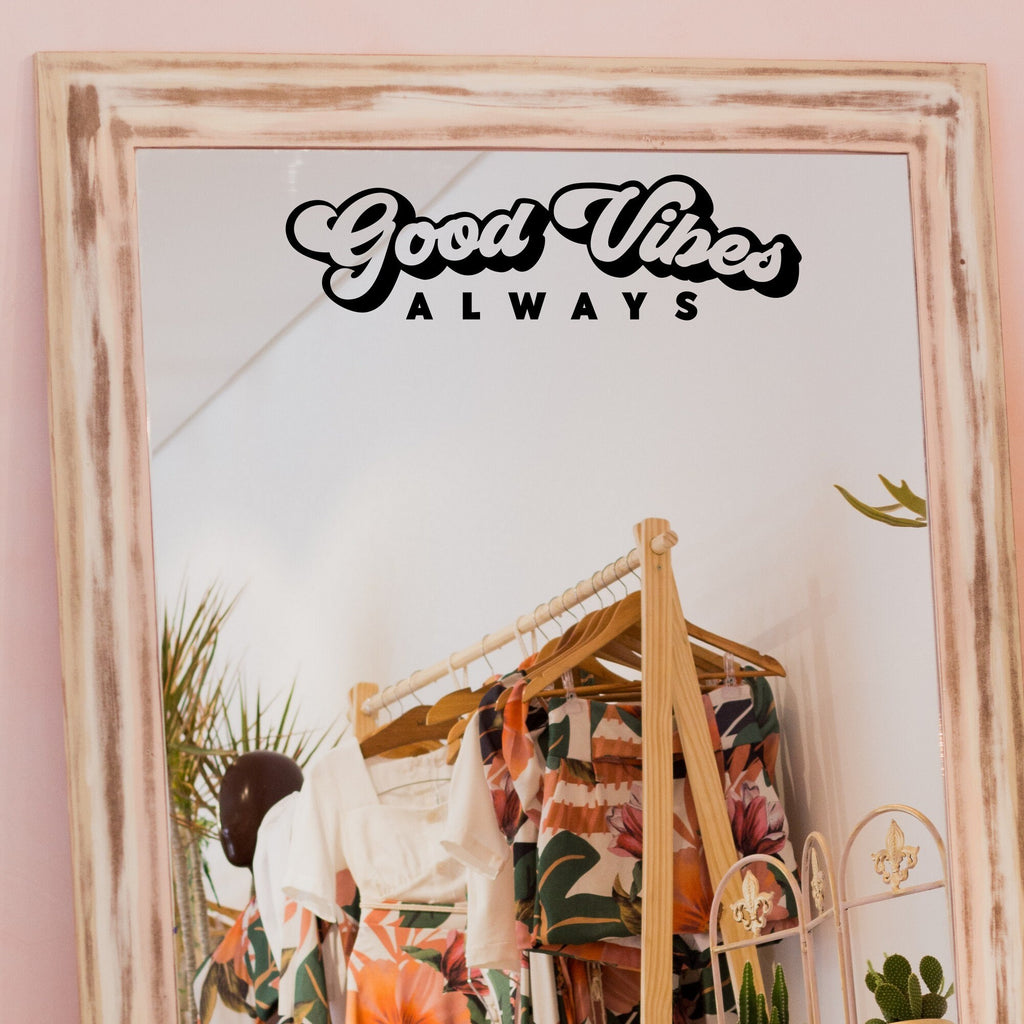 Black “Good Vibes Always” vinyl sticker on a framed dressing-room mirror