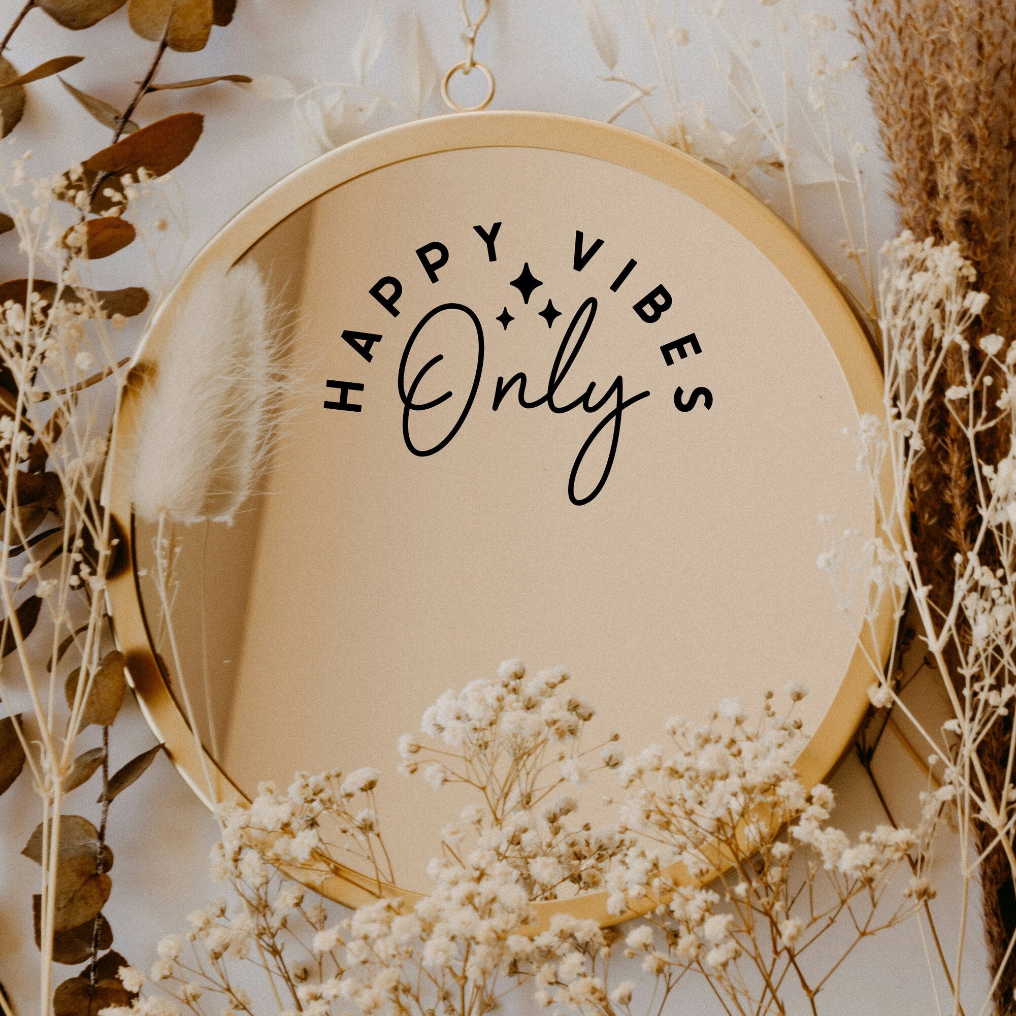 Black “Happy Vibes Only” vinyl sticker on a round mirror with dried flowers