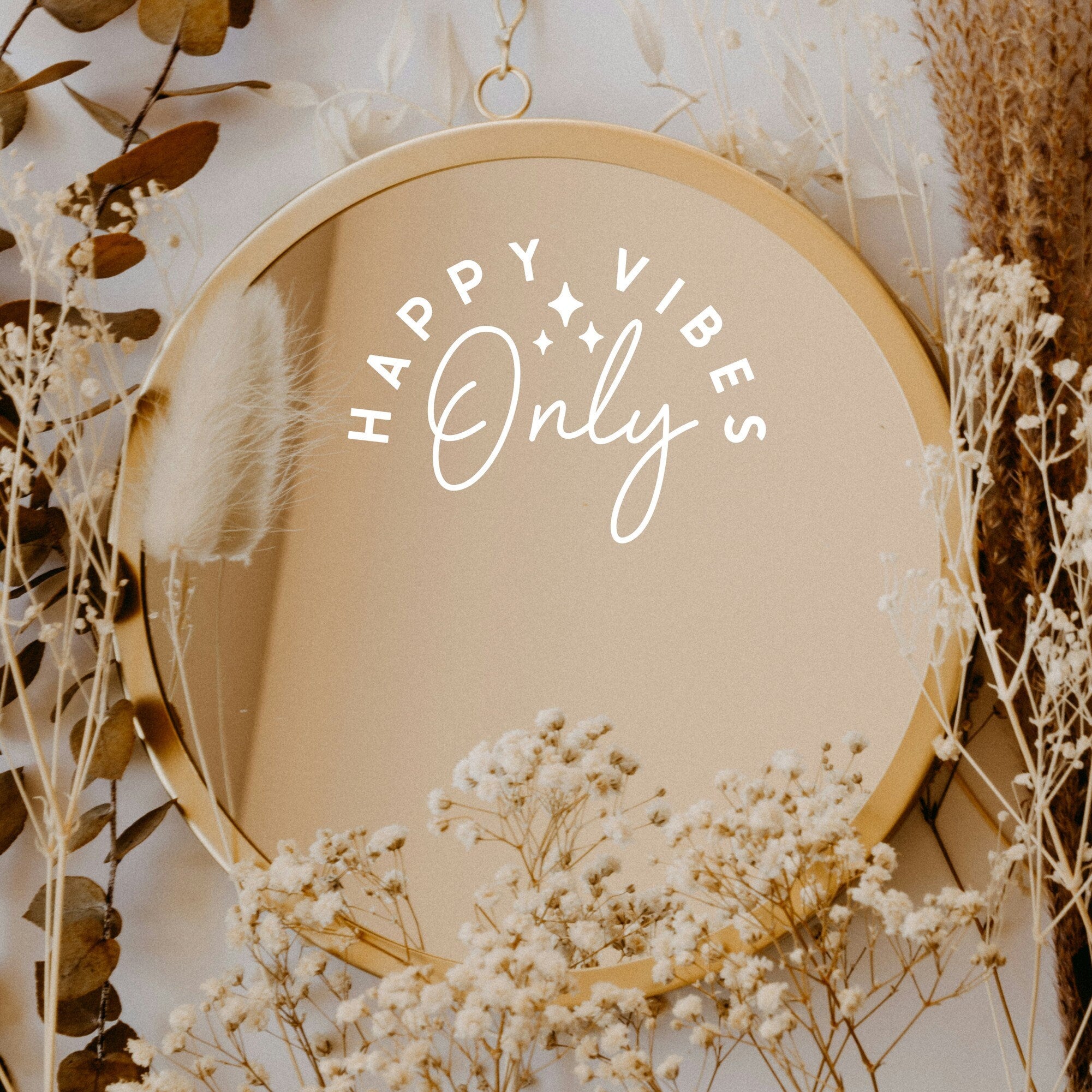 White “Happy Vibes Only” vinyl sticker on a round mirror with dried flowers