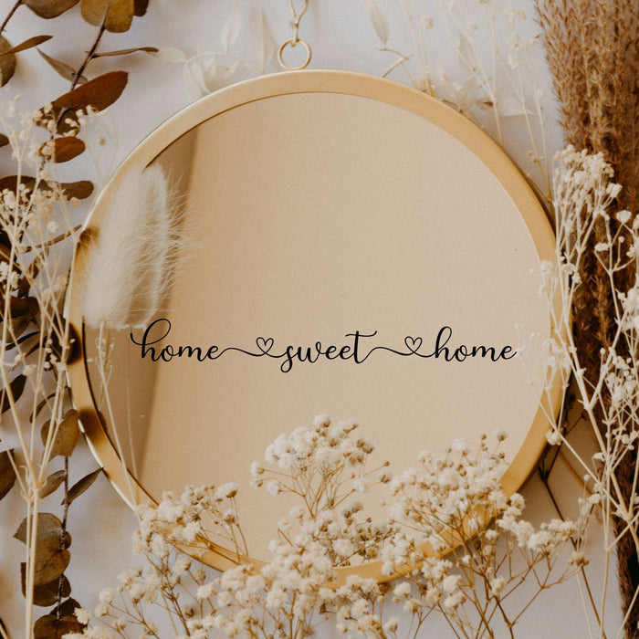 Black “Home Sweet Home” vinyl sticker on a round mirror with dried flowers