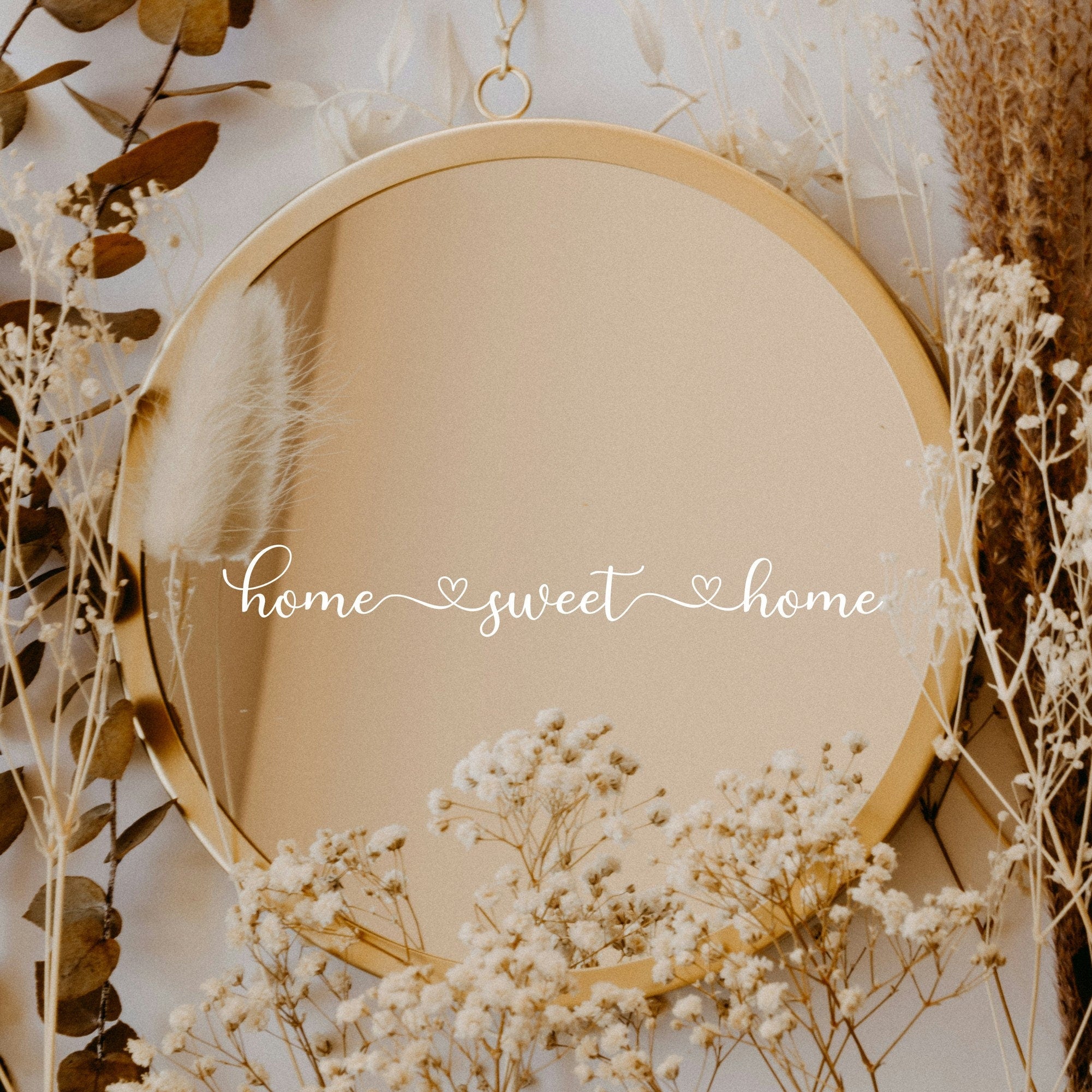 White “Home Sweet Home” vinyl sticker on a round mirror with dried flowers