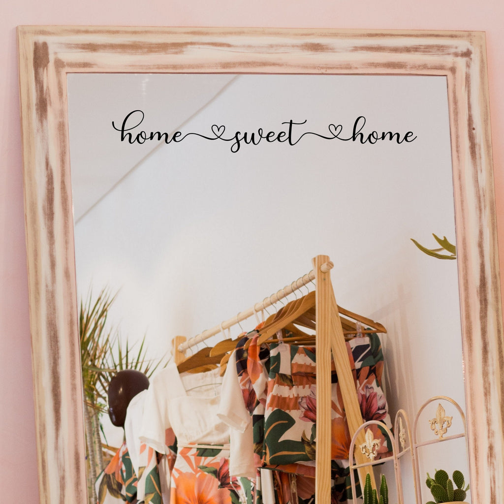 Black “Home Sweet Home” vinyl sticker on a framed dressing-room mirror