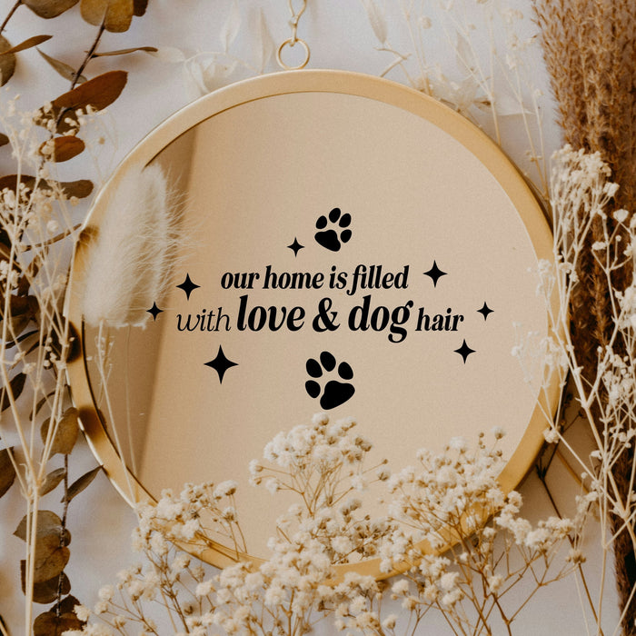 Black “Our Home Is Filled With Love & Dog Hair” vinyl sticker on a round mirror with dried flowers