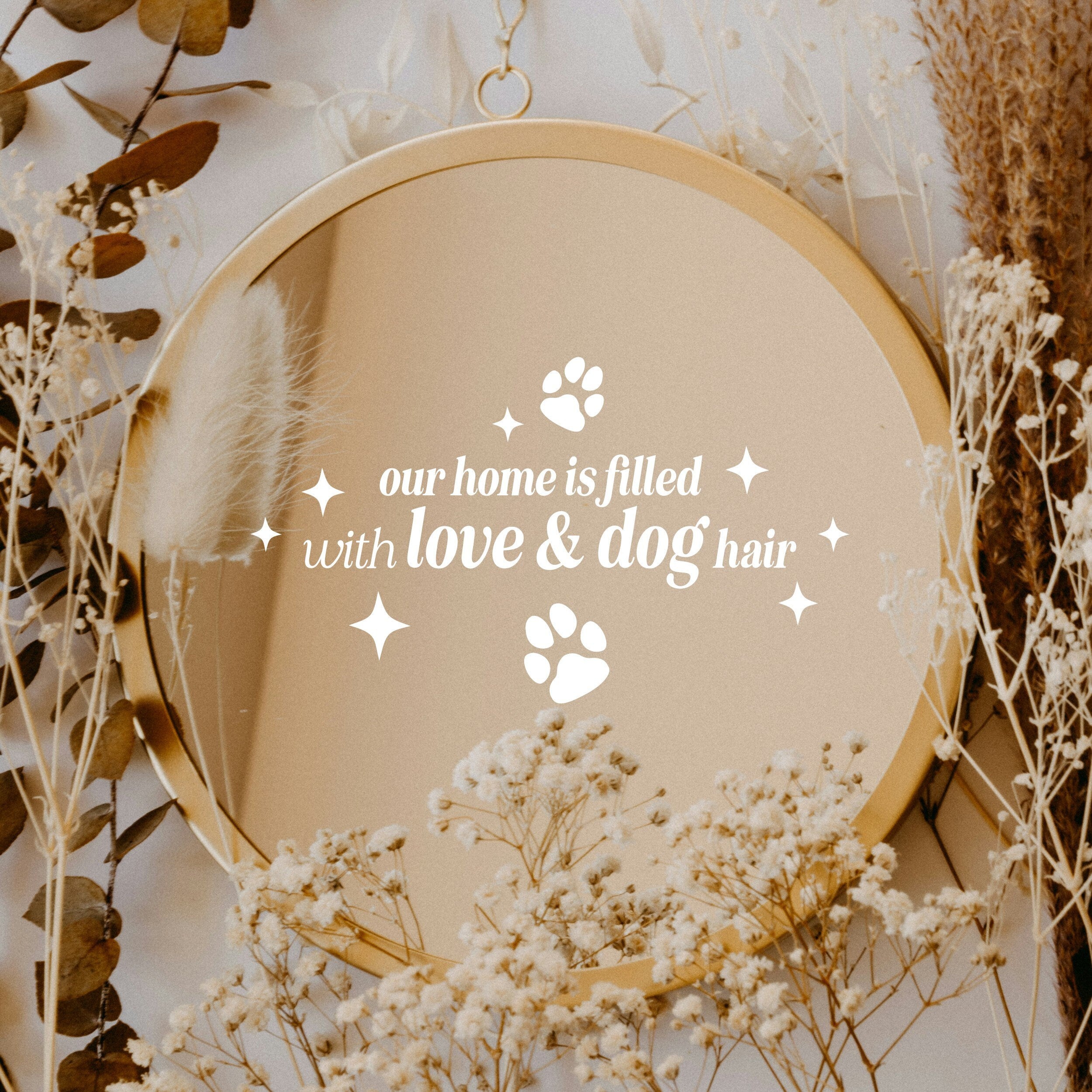 White “Our Home Is Filled With Love & Dog Hair” vinyl sticker on a round mirror with dried flowers