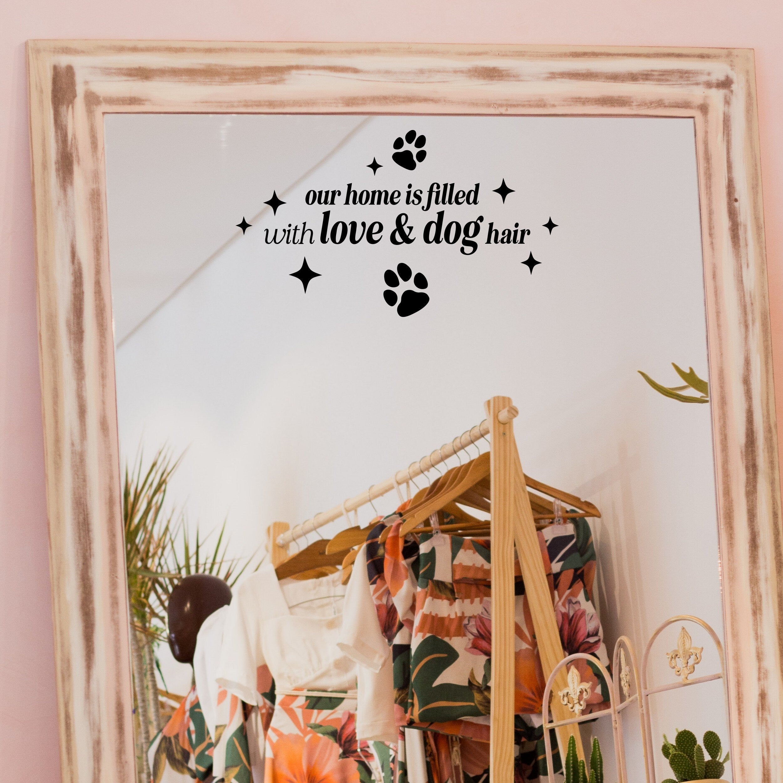 Black “Our Home Is Filled With Love & Dog Hair” vinyl sticker on a framed dressing-room mirror