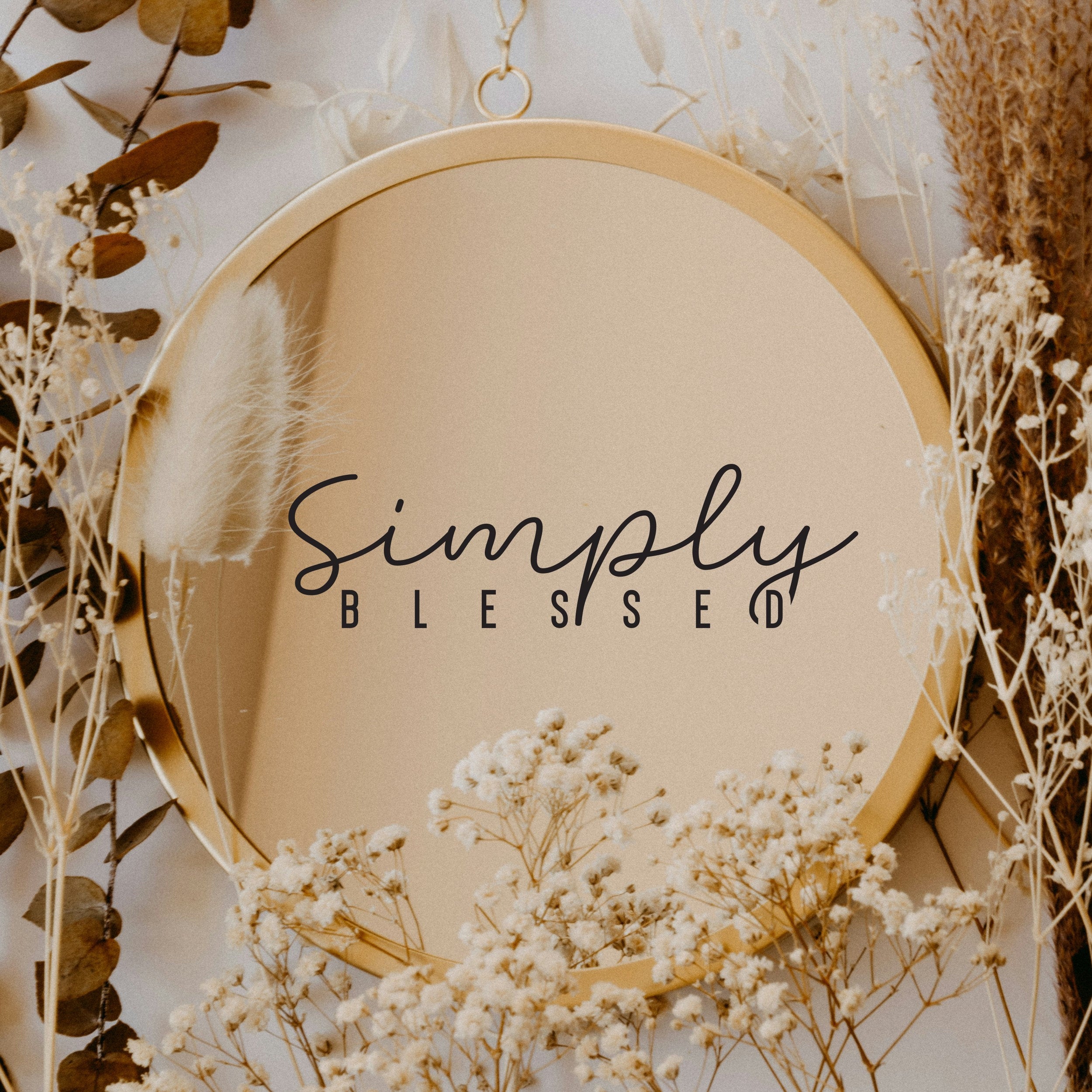 Black “Simply Blessed” vinyl sticker on a round mirror with dried flowers
