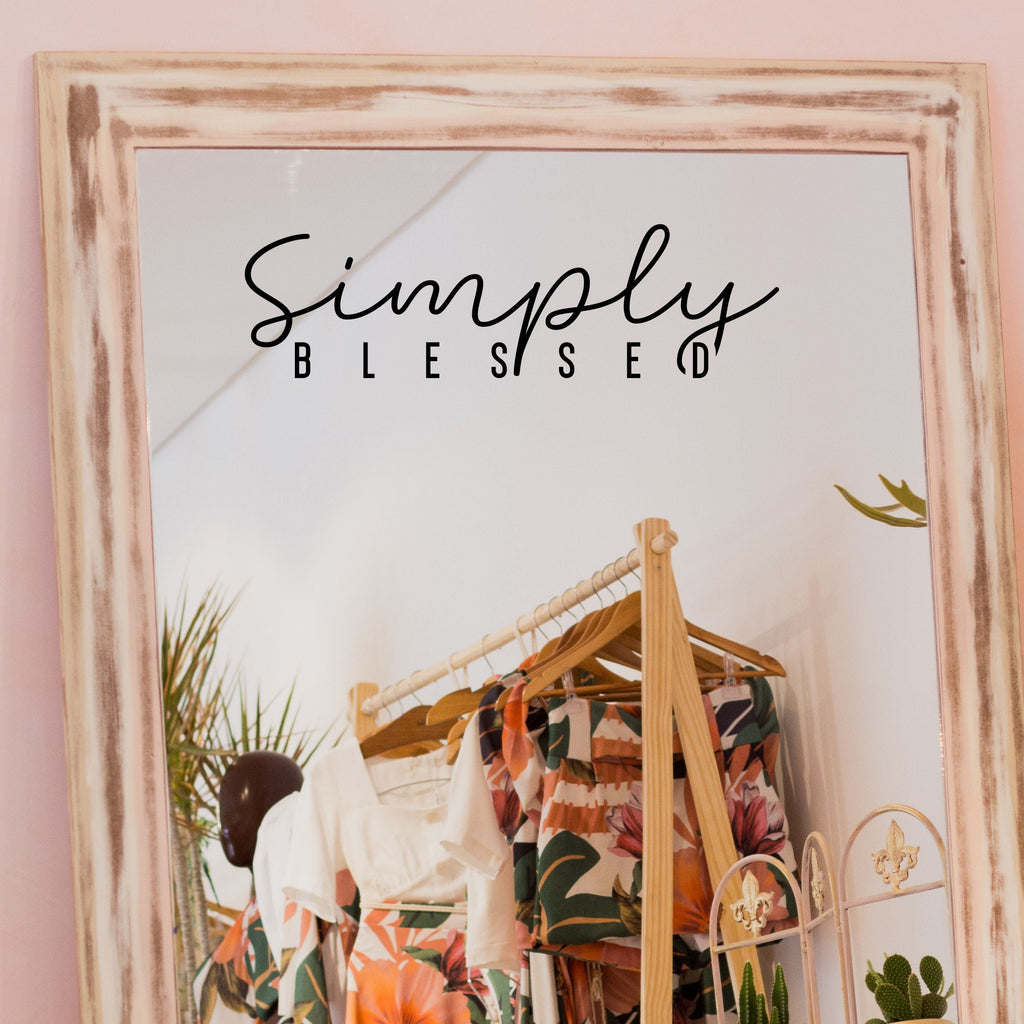 Black “Simply Blessed” vinyl sticker on a framed dressing-room mirror
