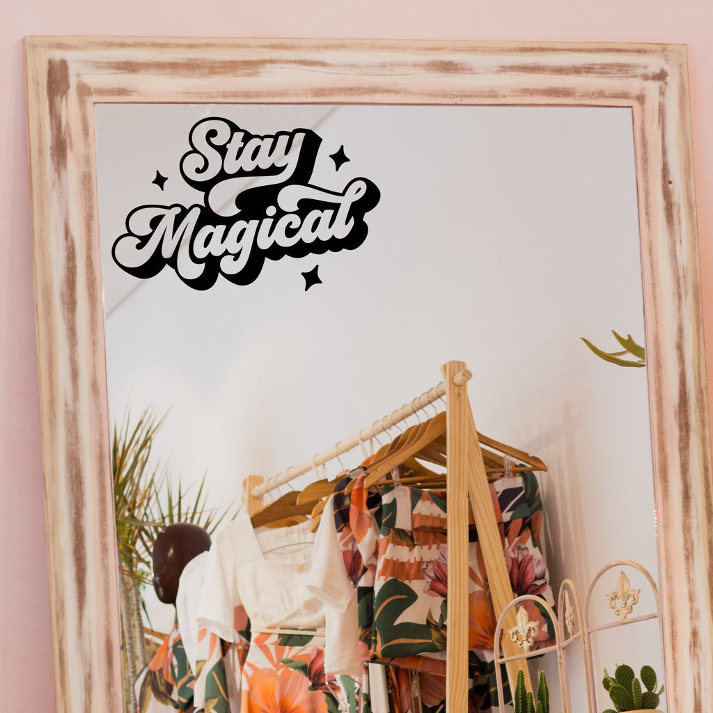 Black “Stay Magical” vinyl sticker on a framed dressing-room mirror