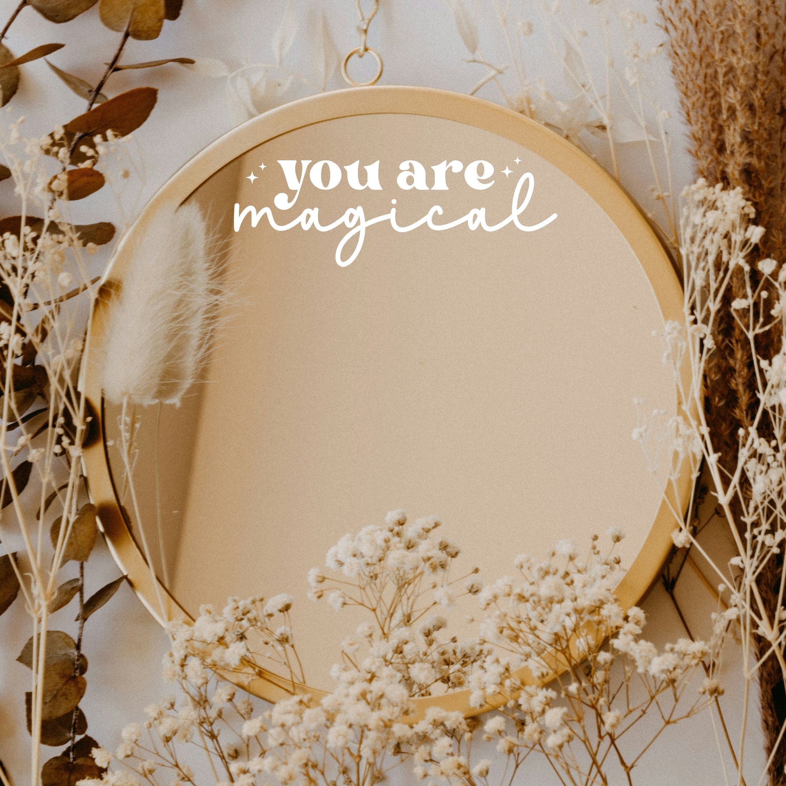 White “You Are Magical” vinyl sticker on a round mirror with dried flowers