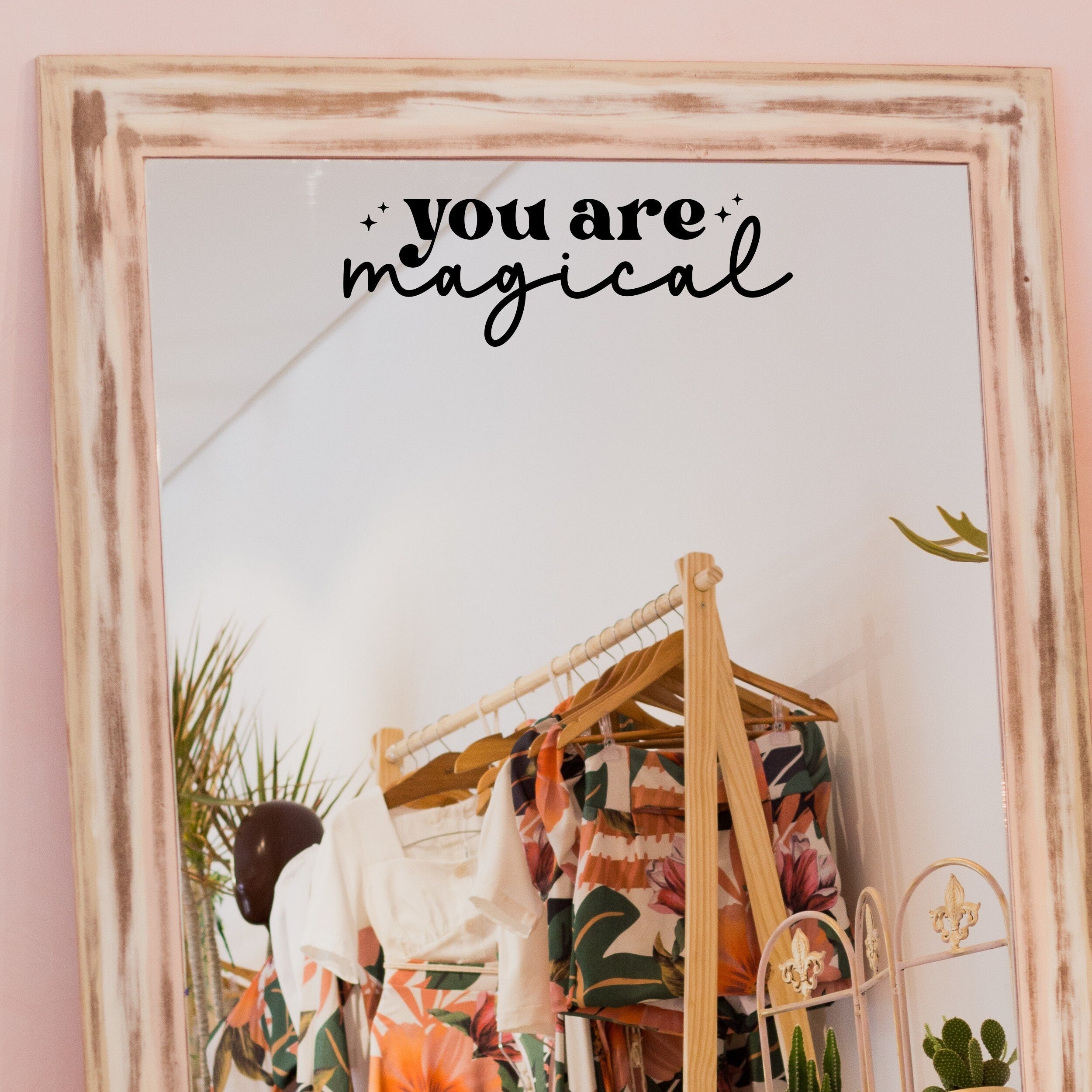 Black “You Are Magical” vinyl sticker on a framed dressing-room mirror