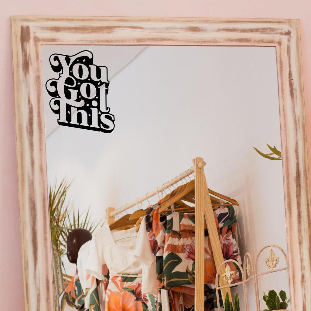Black “You Got This” vinyl sticker on a framed dressing-room mirror