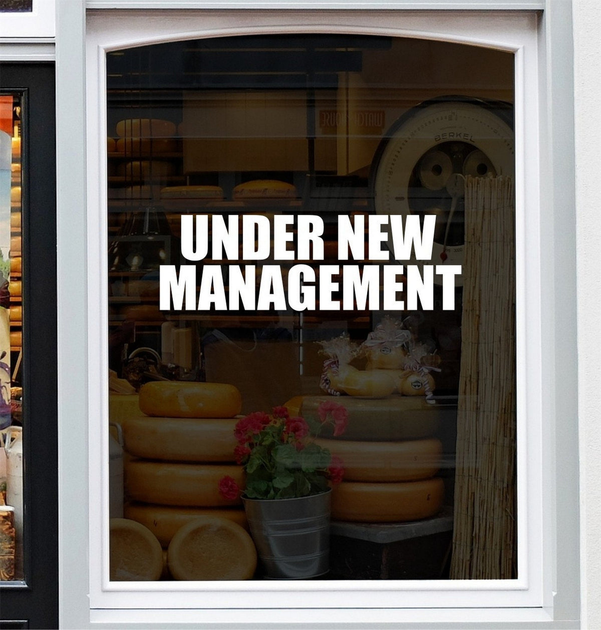 Under New Management Shop Window Sticker shown in a shop window display