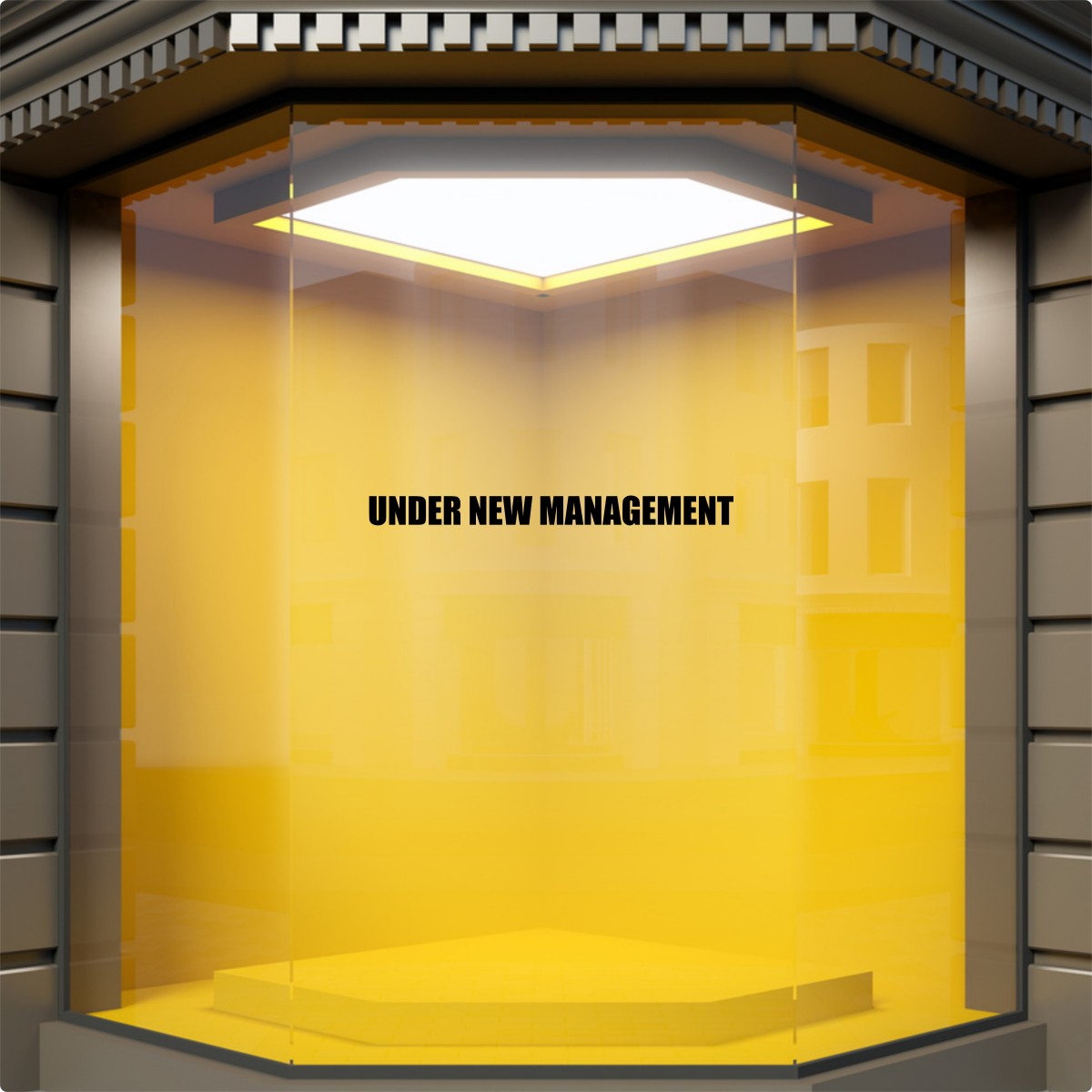 Black Under New Management window sticker on a yellow retail display