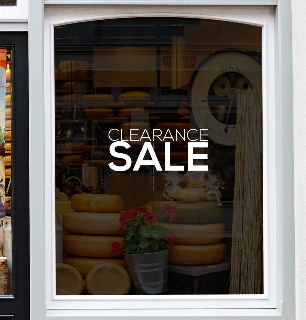 White Clearance Sale window lettering shown on a shop display
