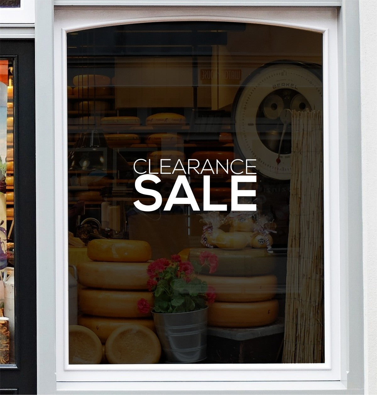 White Clearance Sale window lettering shown on a shop display