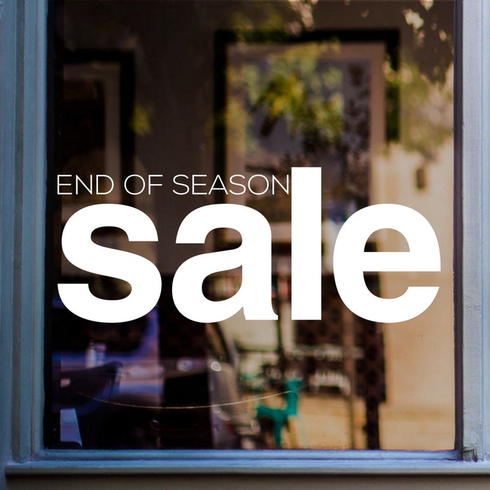 End of Season Sale Shop Window Sticker shown on a blue-framed shop window