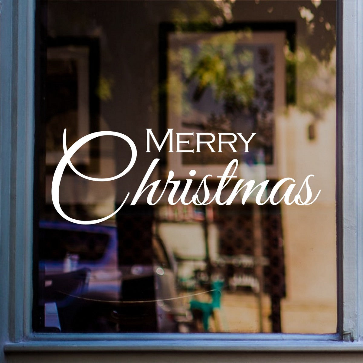 Elegant white Merry Christmas vinyl sticker on a café shop window