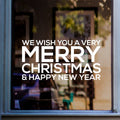White Merry Christmas and Happy New Year vinyl sticker on a shop window