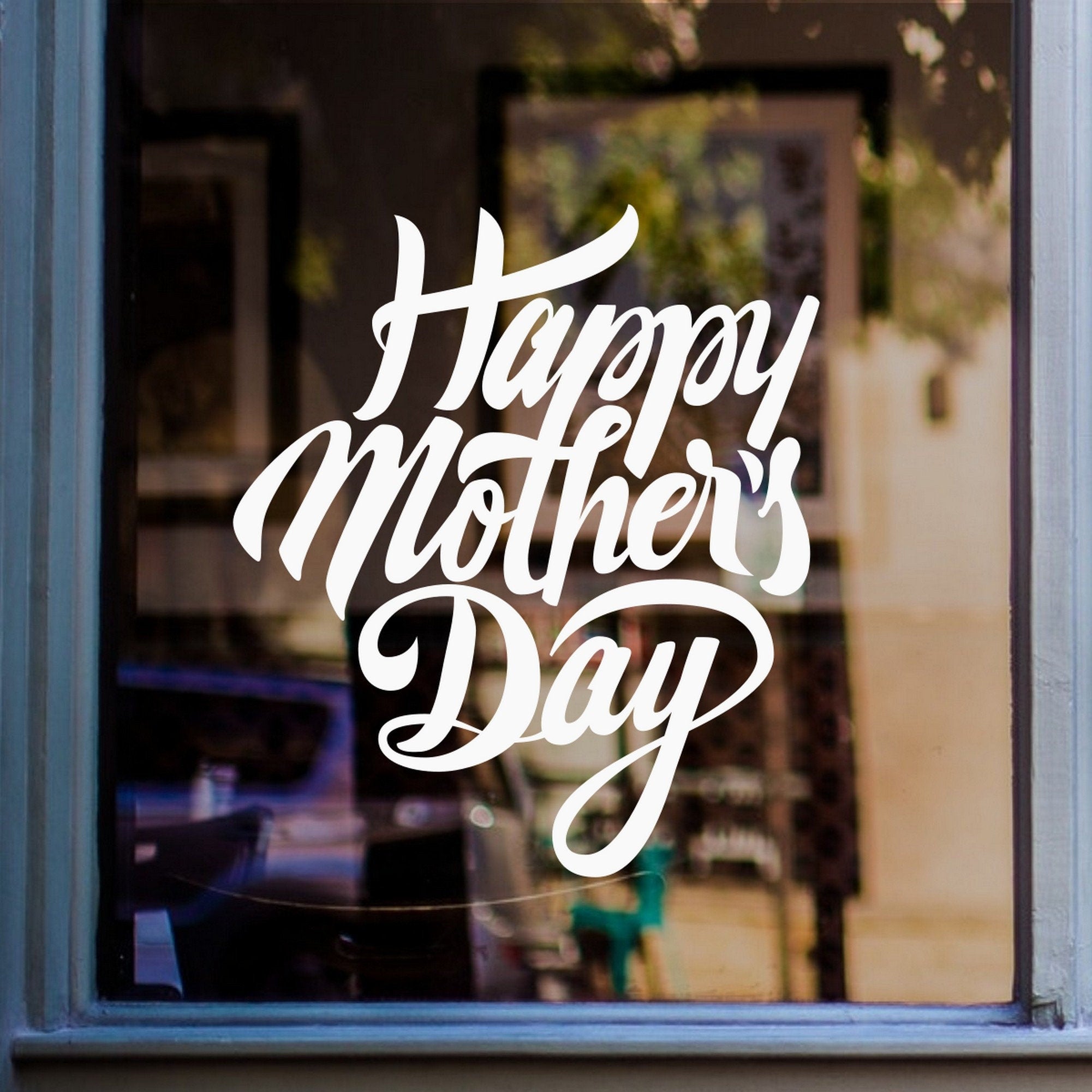 Script Happy Mother’s Day Shop Window Sticker shown on a blue-framed shop window