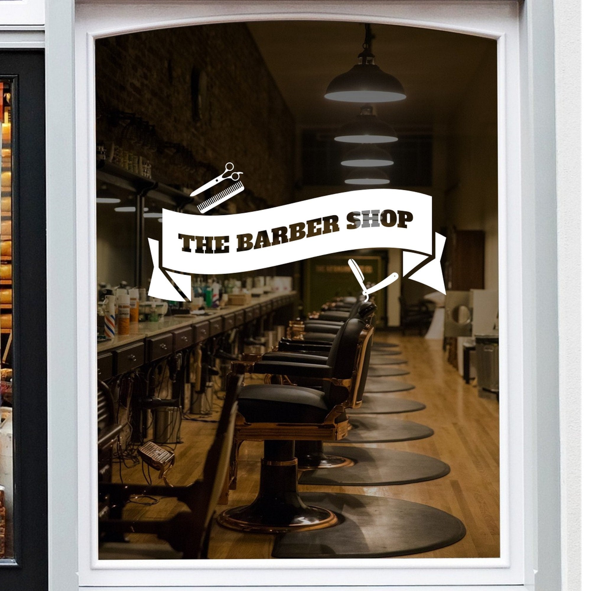 The Barber Shop Banner Window Sticker shown on a shop window