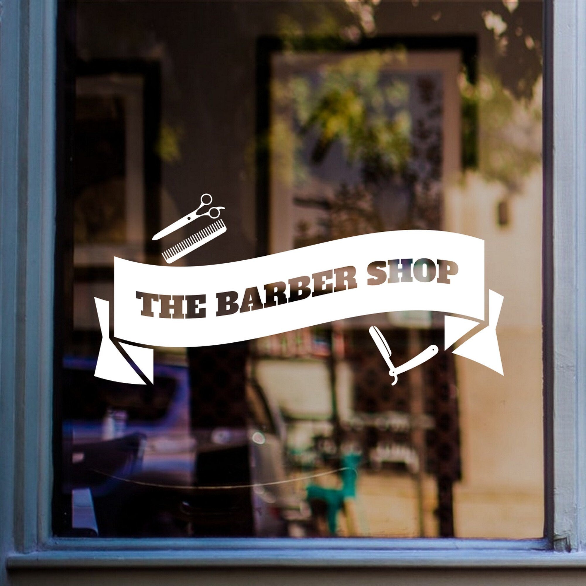The Barber Shop Banner Window Sticker shown in a retail window display