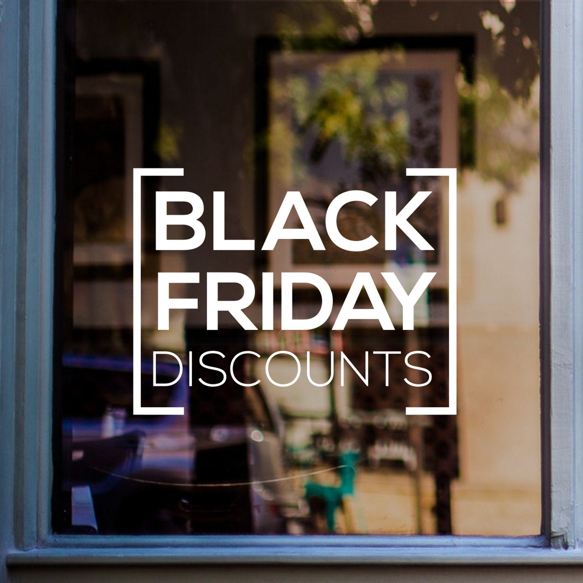 Black Friday Discounts sticker on a blue-framed shop window