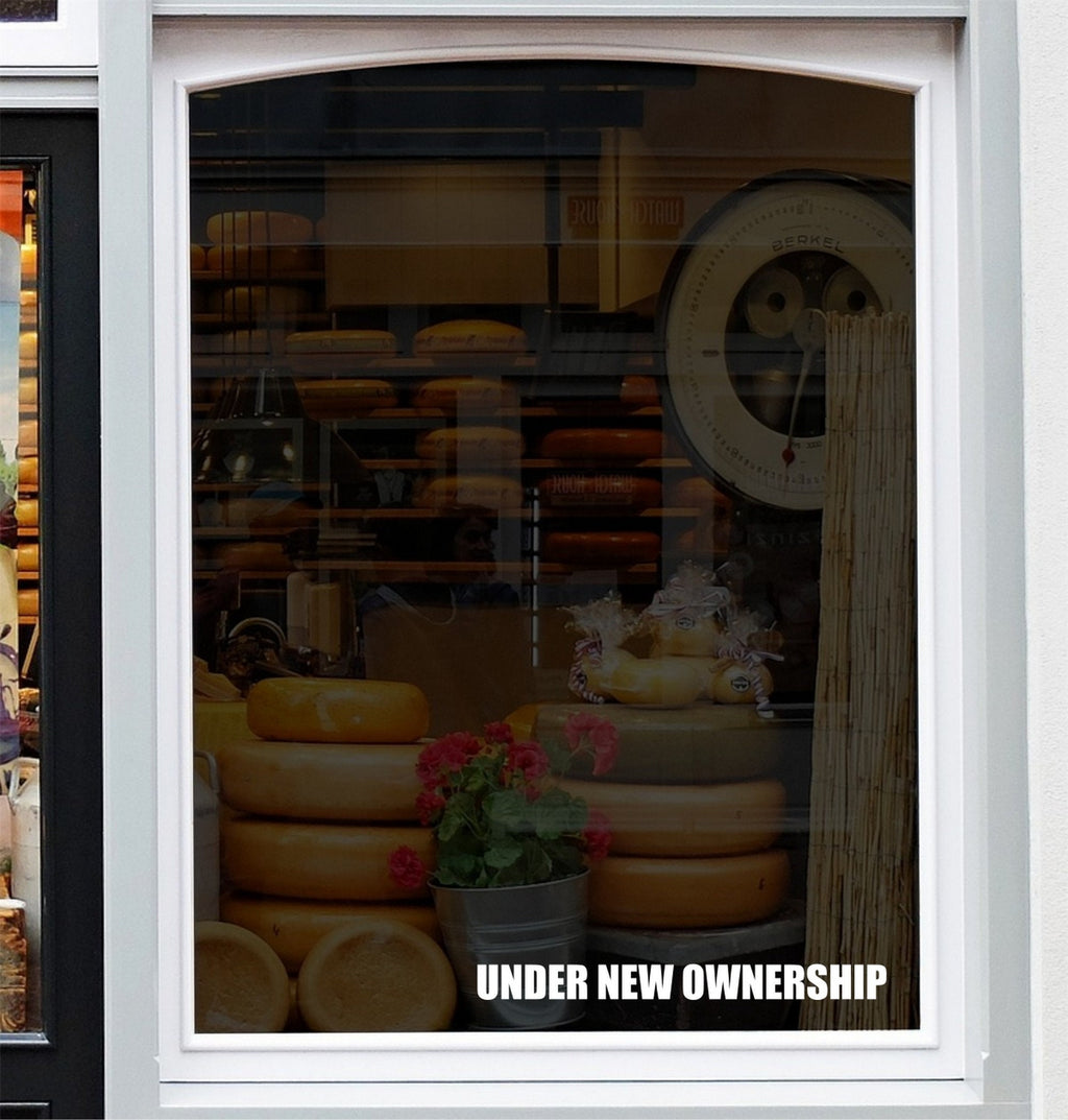 Under New Ownership Shop Window Sticker displayed on a storefront glass pane
