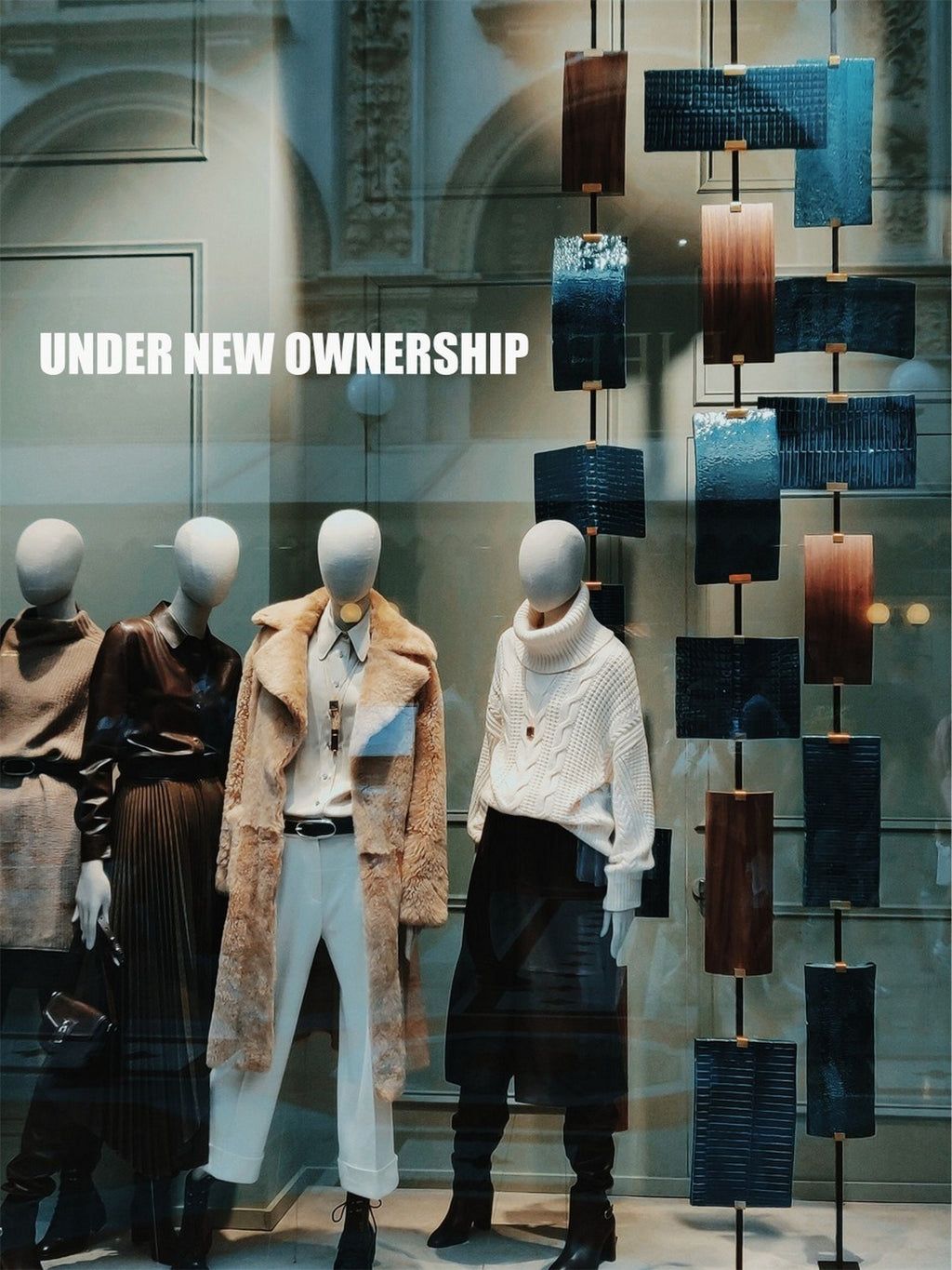 Under New Ownership Shop Window Sticker shown in an alternative retail window setting