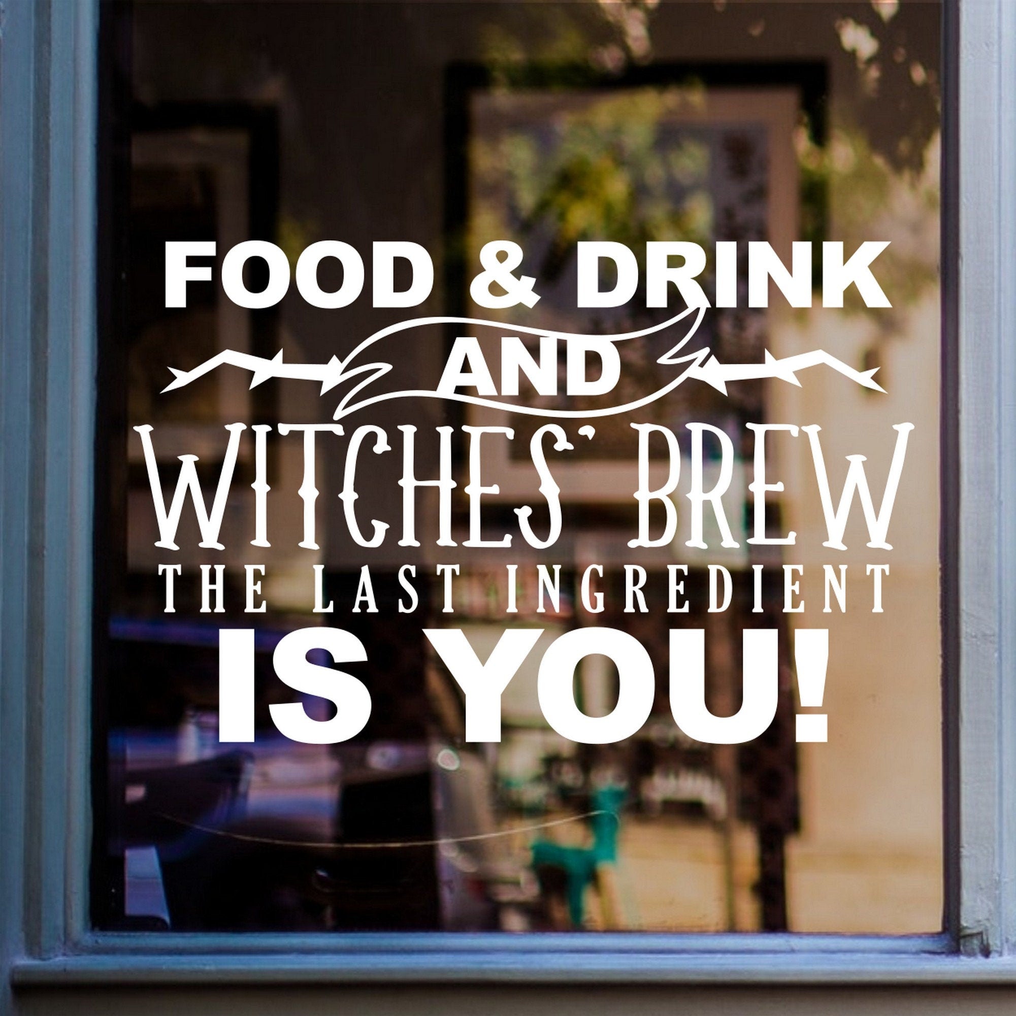 Witches Brew Halloween Window Sticker shown on a shop window