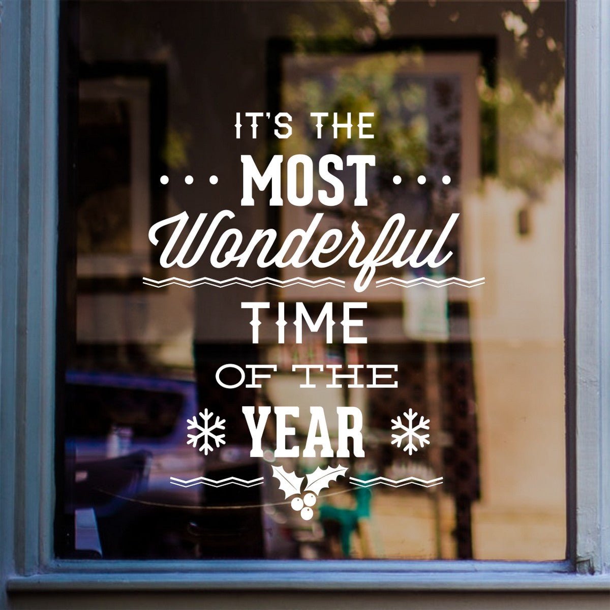 White Most Wonderful Time of the Year Christmas decal on a shop window