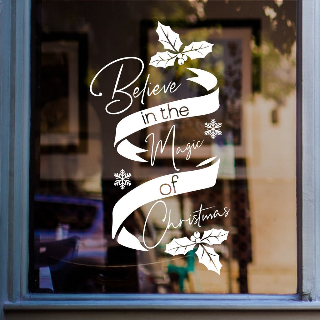 White Believe in the Magic of Christmas sticker on a home window