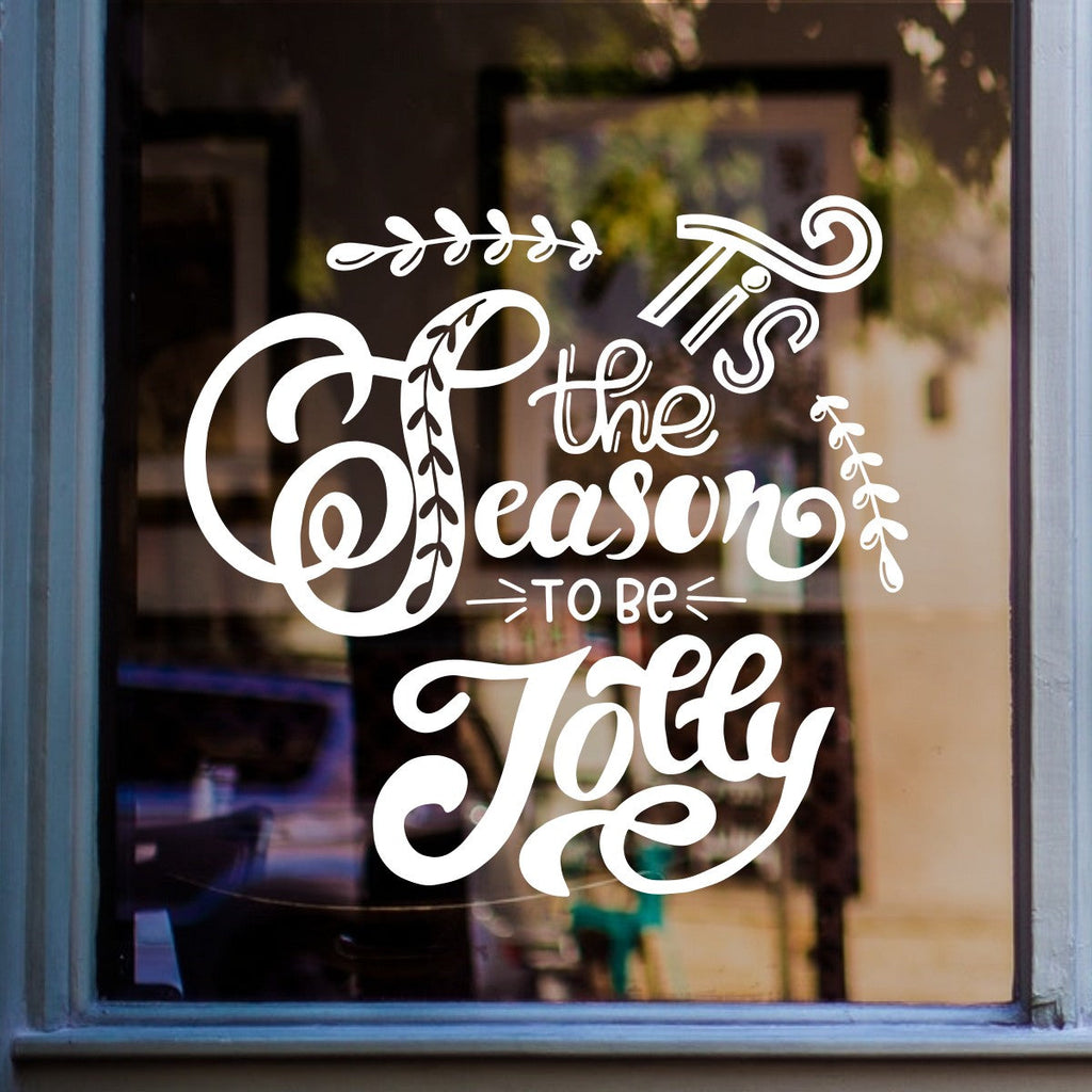 White Tis the Season to Be Jolly sticker on a shop window