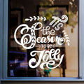 White Tis the Season to Be Jolly sticker on a shop window