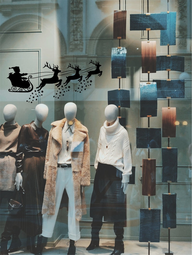 Black Santa sleigh and reindeer Christmas sticker on a fashion shop window