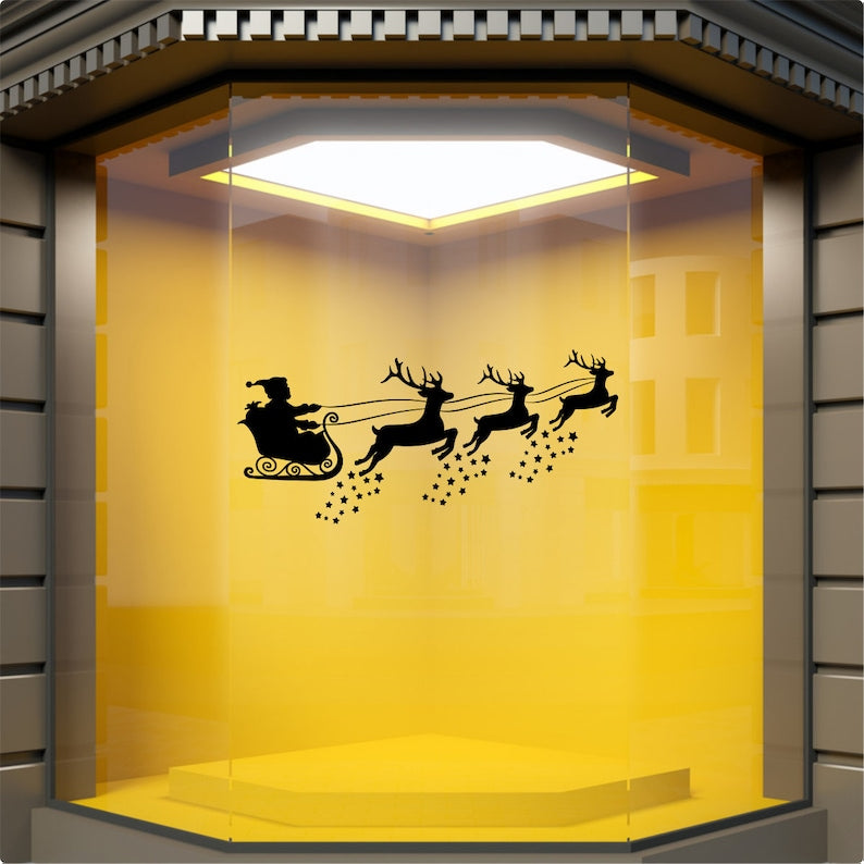 Black Santa sleigh and reindeer Christmas sticker on a yellow shopfront